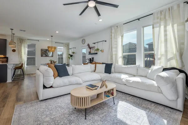 a living room with furniture and a large window