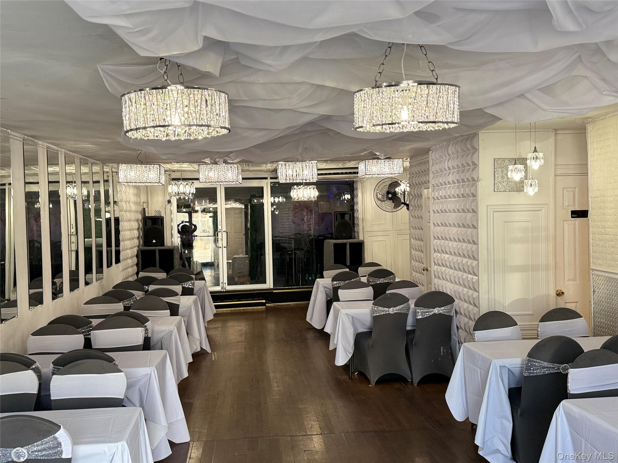 91-08 Sutter Avenue Queens, NY 11417 - Photo 2 of 32 Workout area featuring dark wood-type flooring and a chandelier