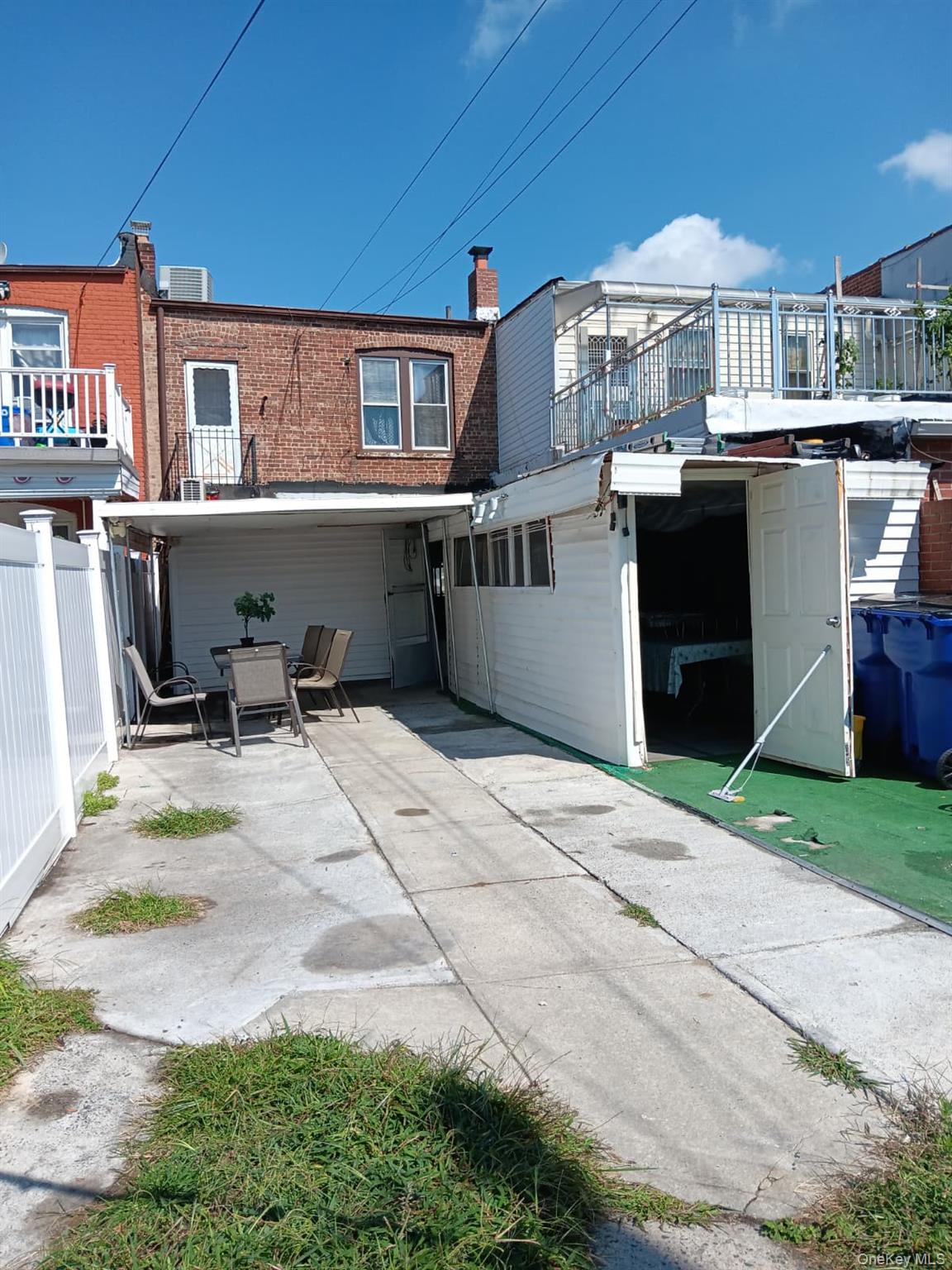 91-08 Sutter Avenue Queens, NY 11417 - Photo 25 of 32 Rear view of house with a patio area