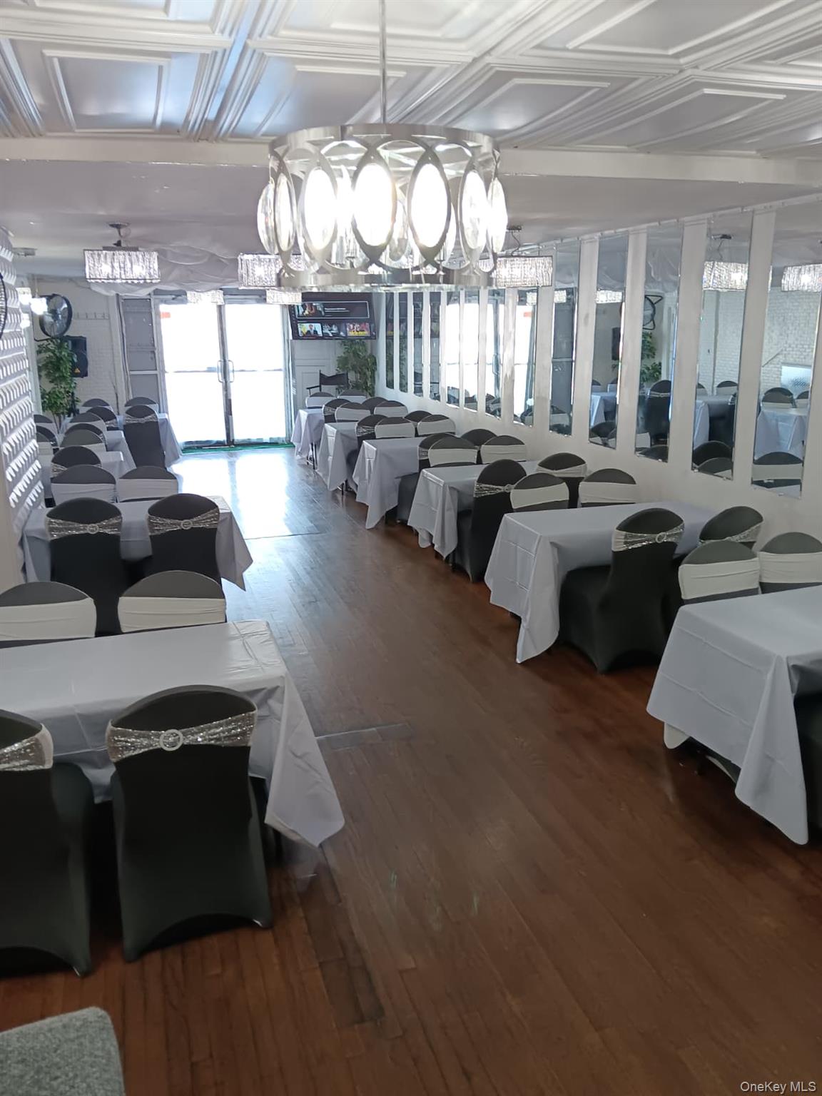 91-08 Sutter Avenue Queens, NY 11417 - Photo 29 of 32 Dining space with dark wood-style flooring, a chandelier, and an ornate ceiling