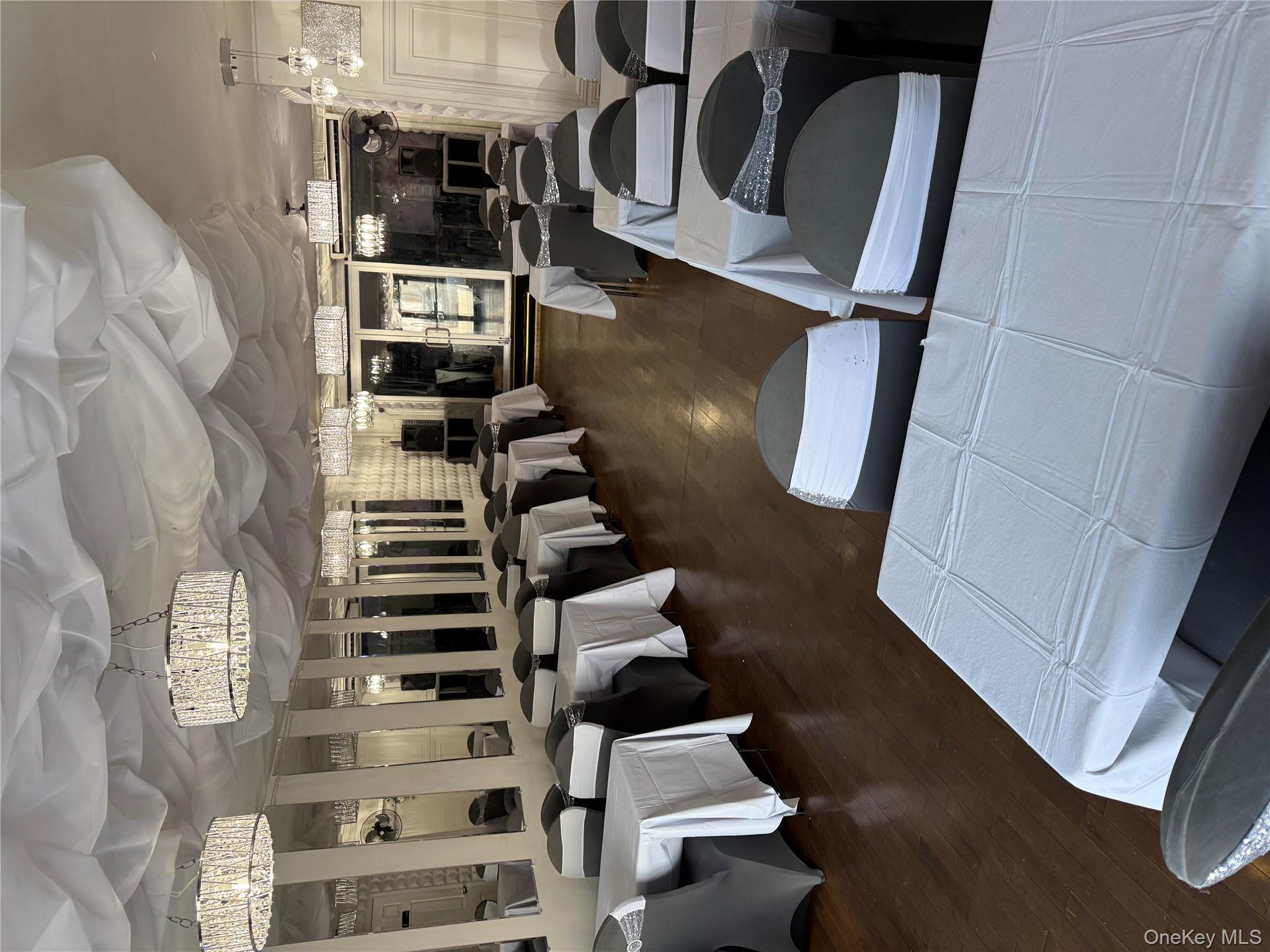 91-08 Sutter Avenue Queens, NY 11417 - Photo 3 of 32 Dining space featuring dark wood-style floors and a chandelier