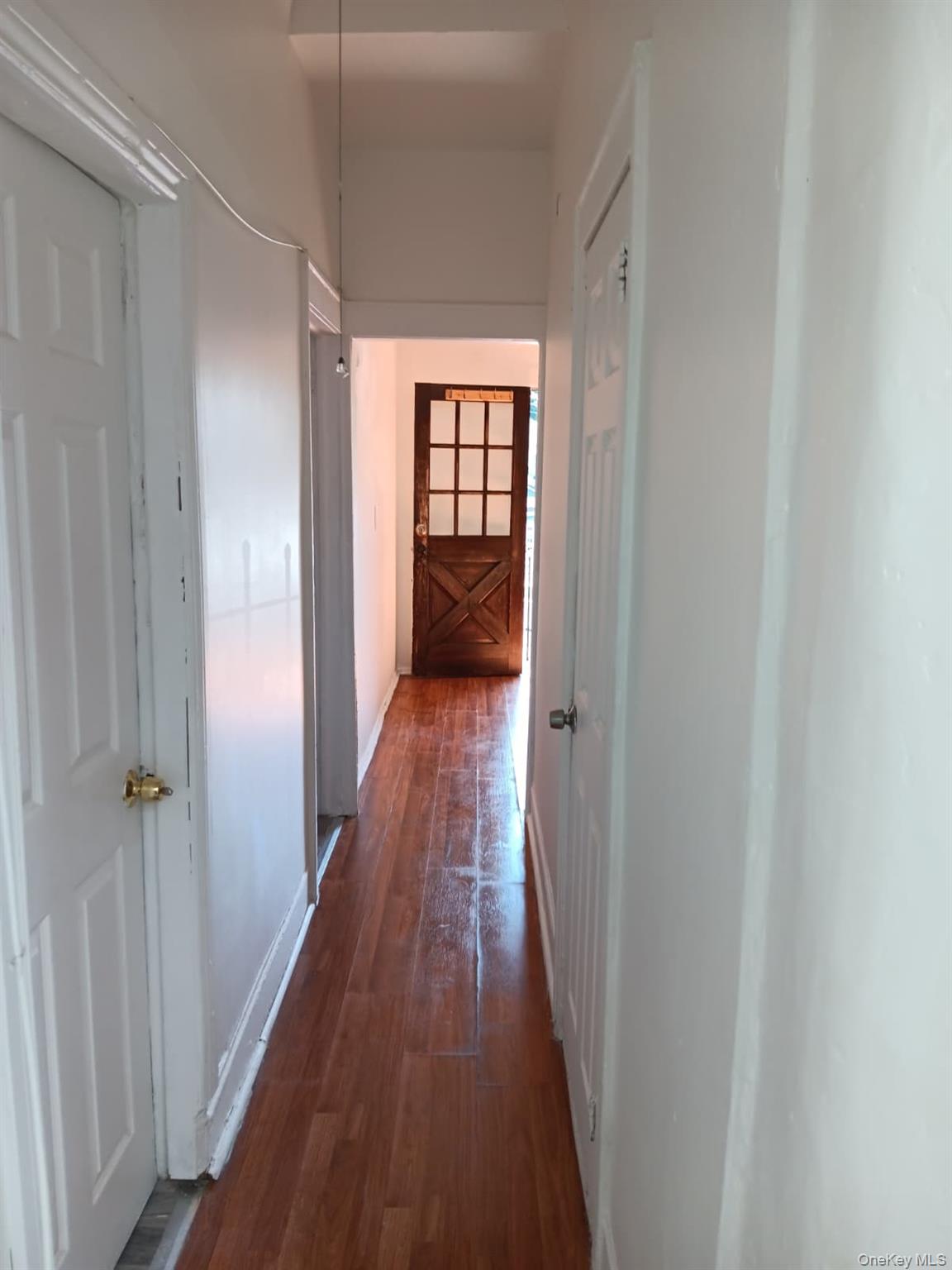 91-08 Sutter Avenue Queens, NY 11417 - Photo 31 of 32 Hallway featuring dark wood-type flooring and baseboards