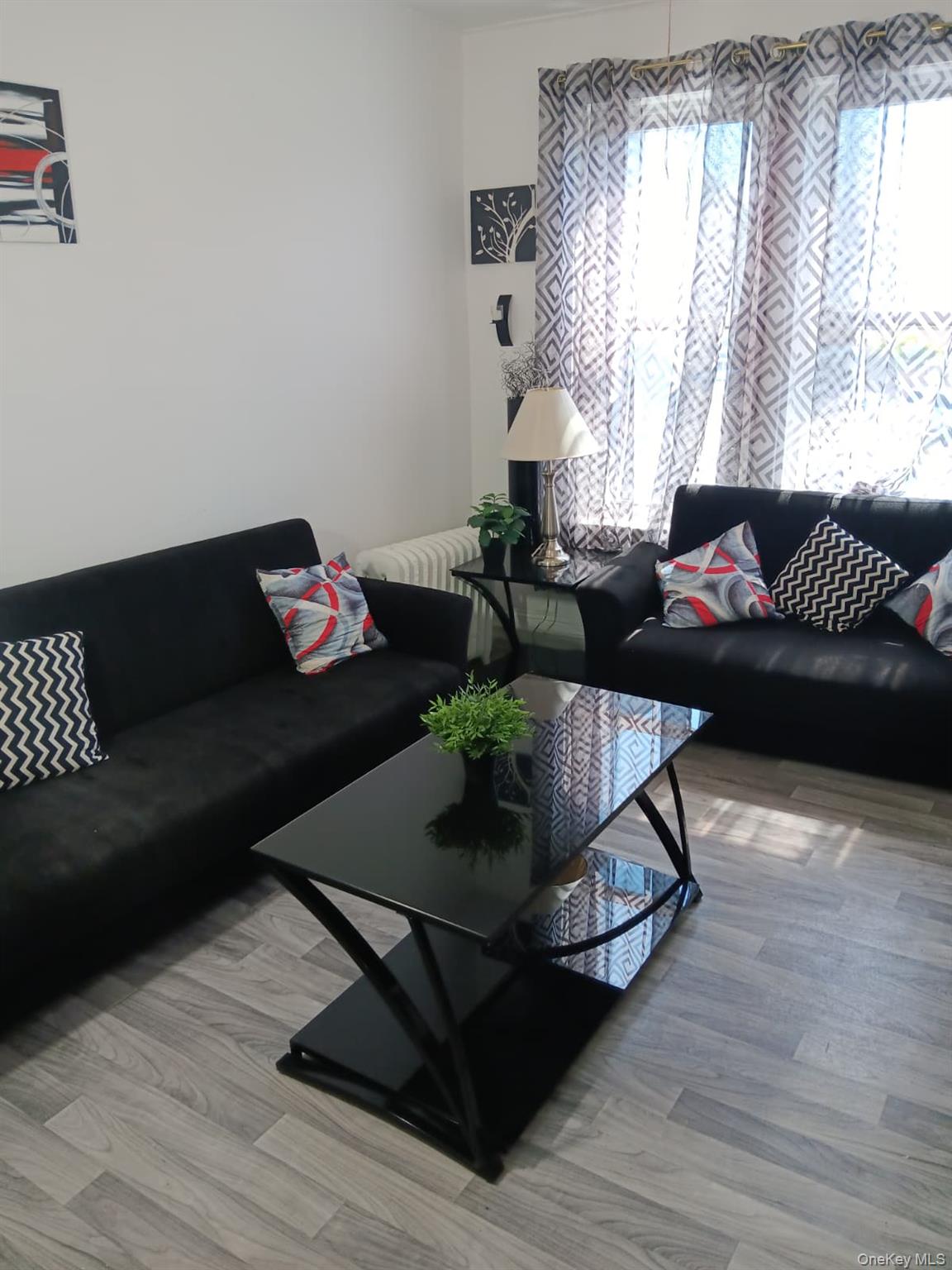 91-08 Sutter Avenue Queens, NY 11417 - Photo 5 of 32 Living area featuring wood finished floors