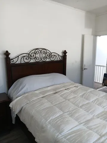 a bedroom with a bed and window