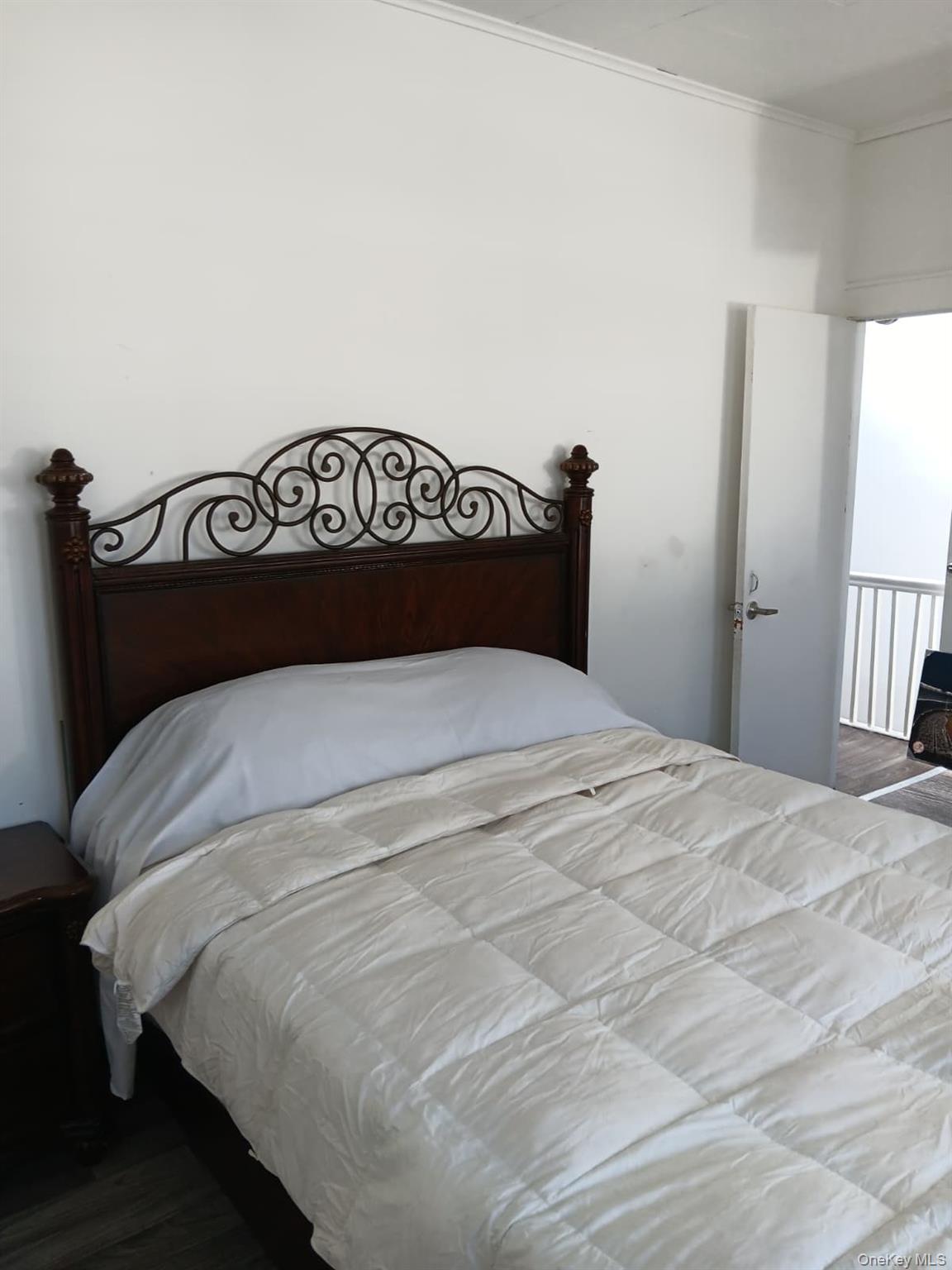 91-08 Sutter Avenue Queens, NY 11417 - Photo 7 of 32 Bedroom featuring dark wood-type flooring and ornamental molding