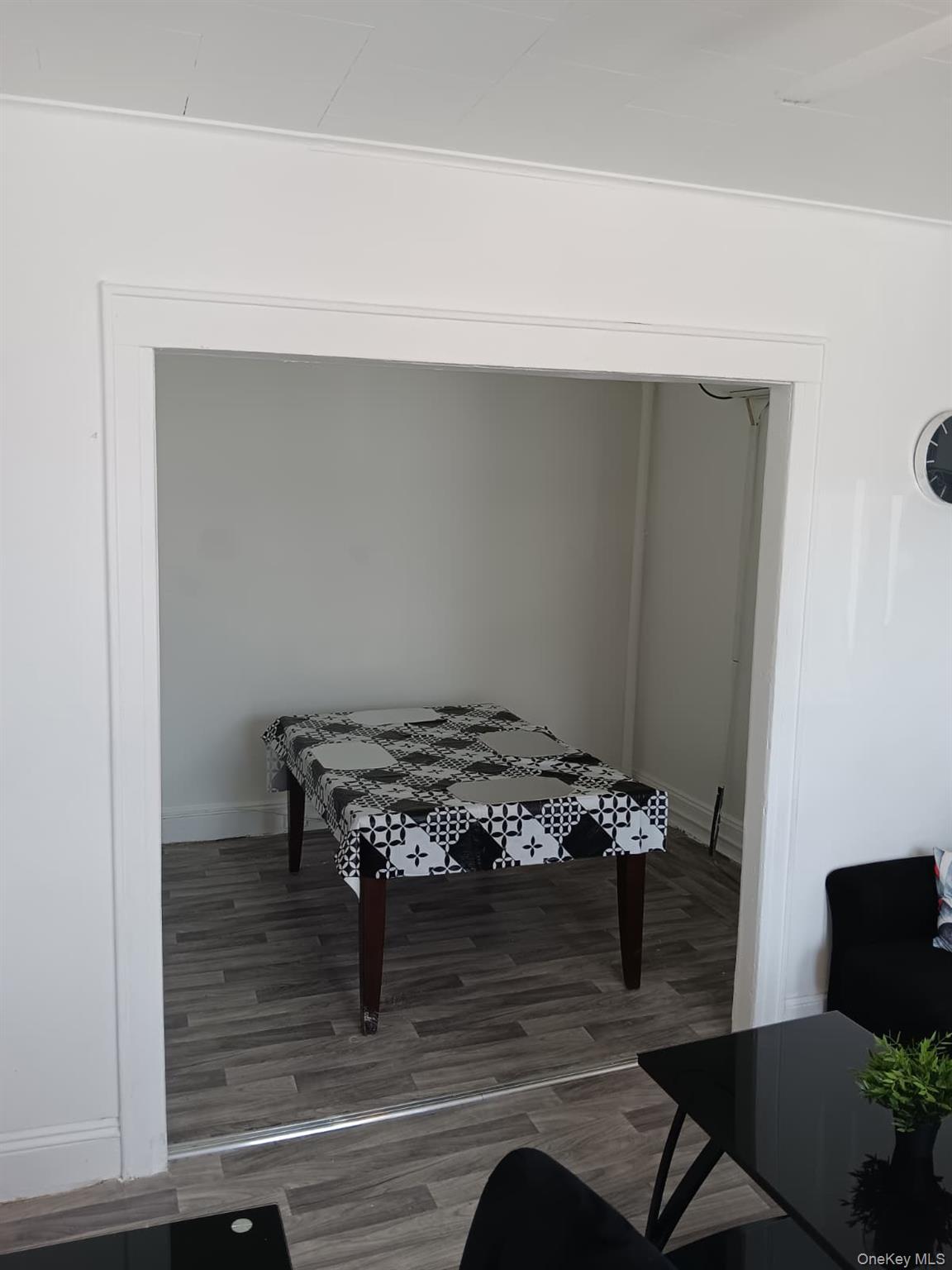 91-08 Sutter Avenue Queens, NY 11417 - Photo 9 of 32 Rec room with wood finished floors and baseboards