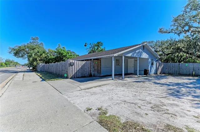 a view of a house with wooden fence