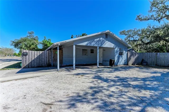 a house with wooden fence in front of it