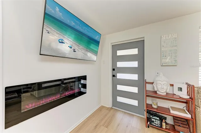 a view of a hallway with wooden floor and cabinet