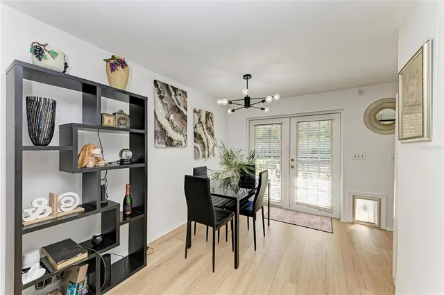 a view of a dining room with furniture and a chandelier