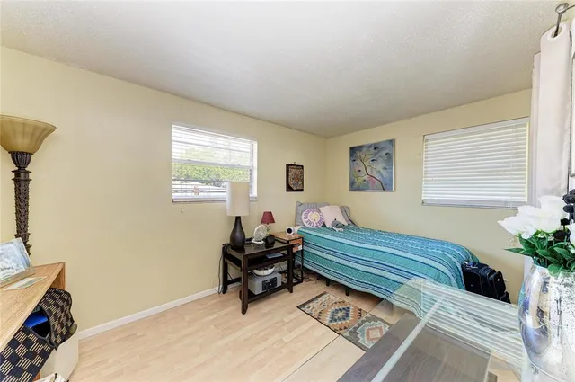 a bed room with a bed and a chair