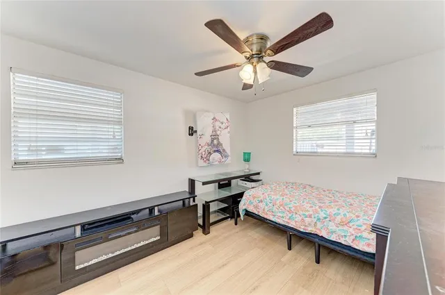 a bedroom with a bed and a chandelier