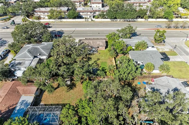 an aerial view of a house with a yard and garden