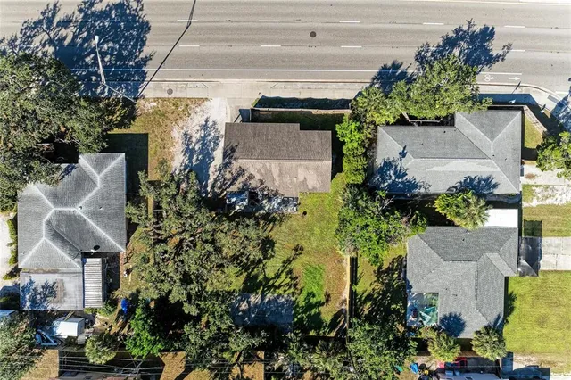 an aerial view of a house with a yard and garden