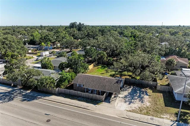 an aerial view of a house with a yard basket ball court