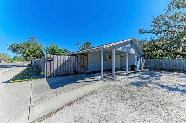 a view of a house with wooden fence