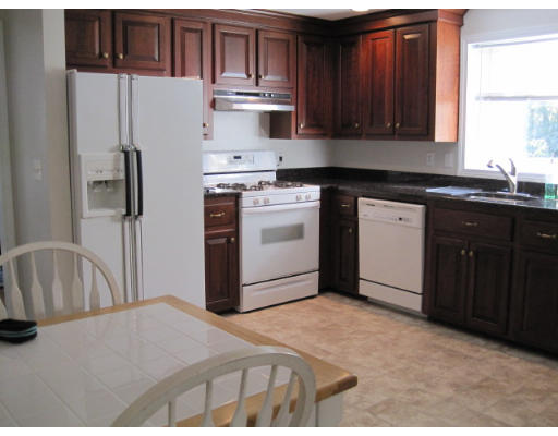 20 Pinewood Road Chelmsford, MA 01824 - Photo 4 of 15 a kitchen with stainless steel appliances granite countertop a refrigerator sink and cabinets