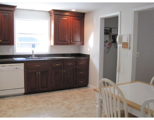 20 Pinewood Road Chelmsford, MA 01824 - Photo 5 of 15 a kitchen with a sink and wooden cabinets