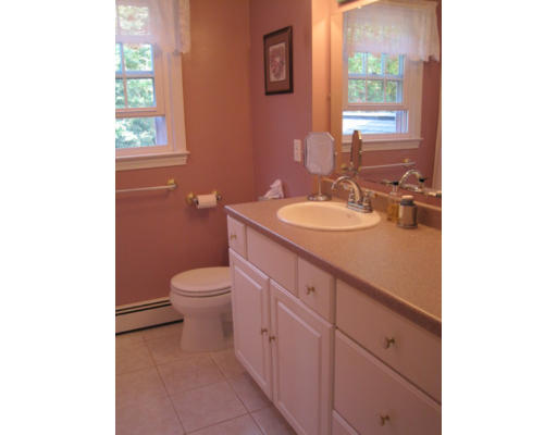 20 Pinewood Road Chelmsford, MA 01824 - Photo 10 of 15 a bathroom with a toilet a sink a mirror and a window