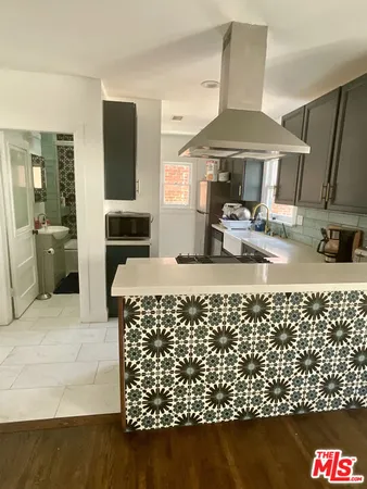 a kitchen with sink and refrigerator