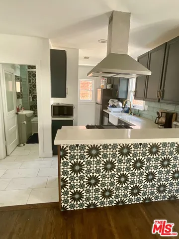 a kitchen with sink and refrigerator