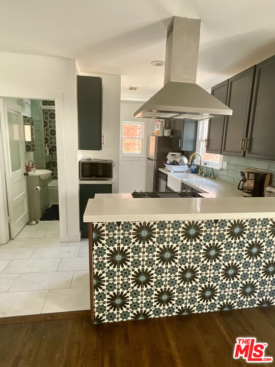 a kitchen with sink and refrigerator