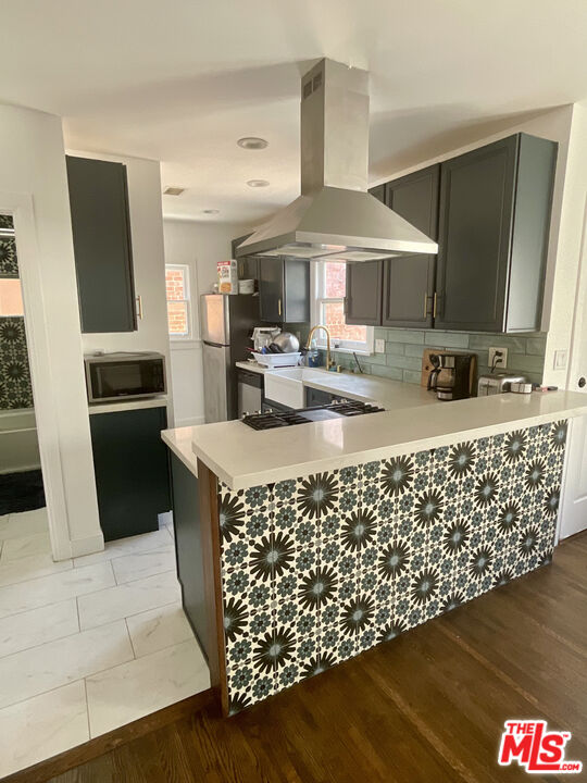 534 West 10th Street Long Beach, CA 90813 - Photo 2 of 9 a kitchen with sink cabinets and wooden floor