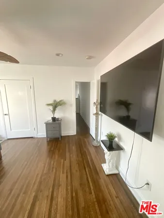 a view of living room with furniture and wooden floor