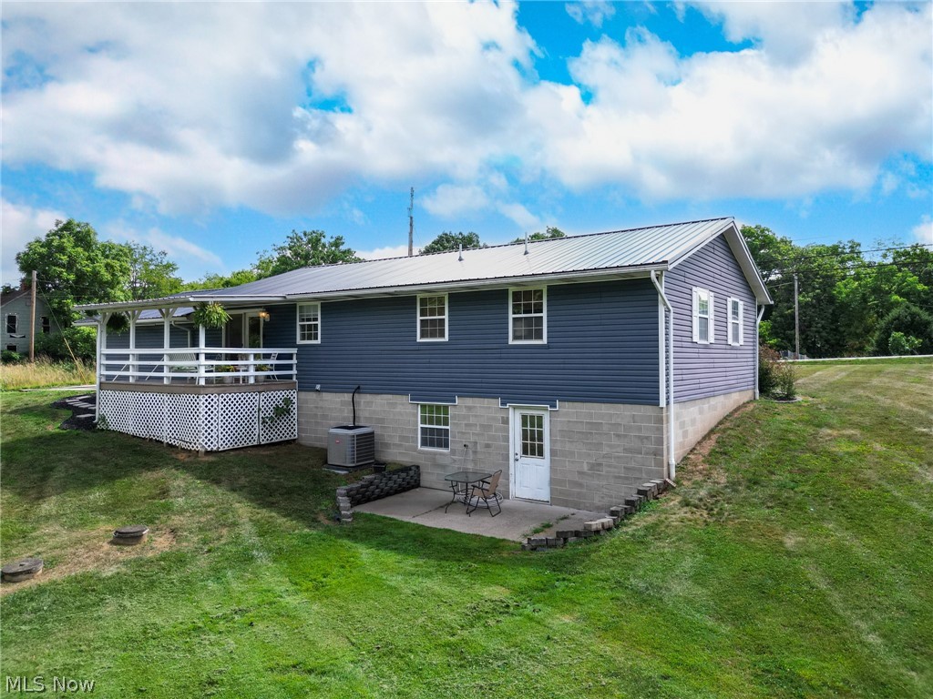 25 Lane Road Vincent, OH 45784 - Photo 30 of 40 Back of property with a yard, a patio, and cooling unit