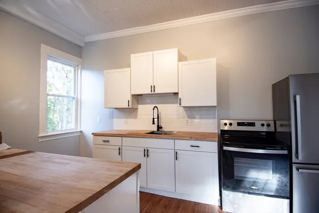 a kitchen with a sink stove and refrigerator