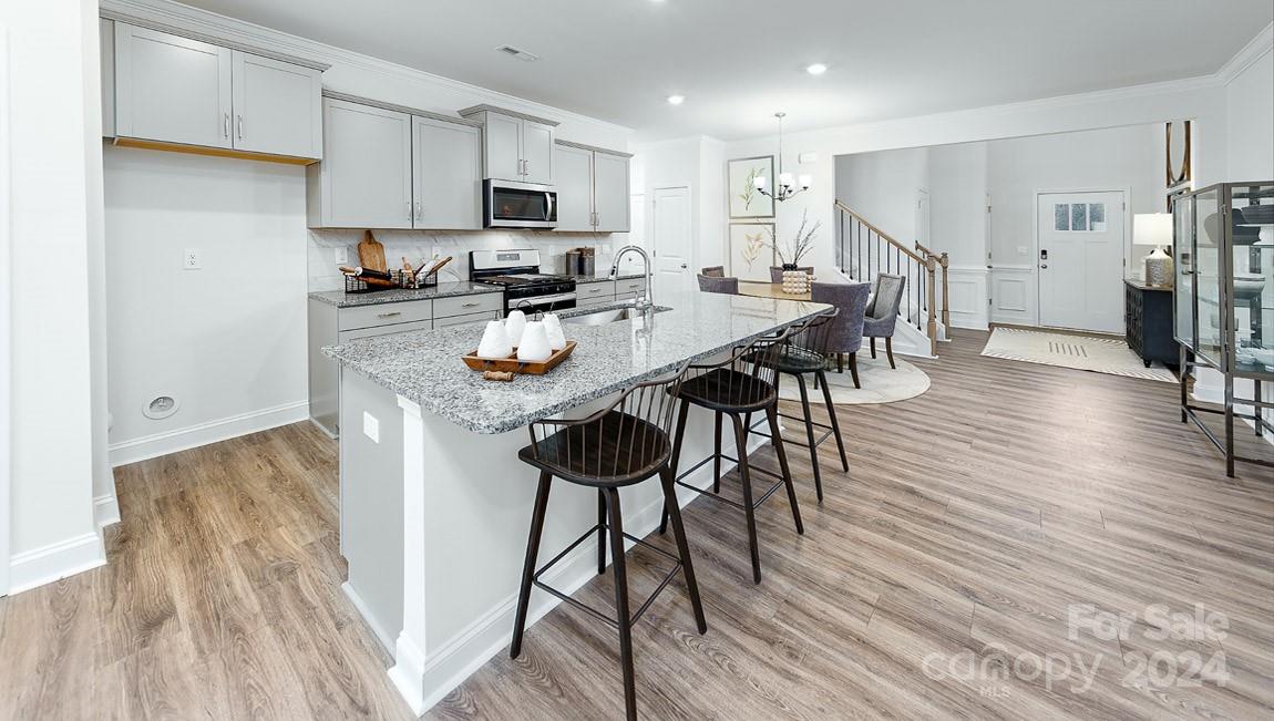 7870 Iron Road Sherrills Ford, NC 28673 - Photo 7 of 39 a kitchen with stainless steel appliances a dining table chairs stove refrigerator and cabinets