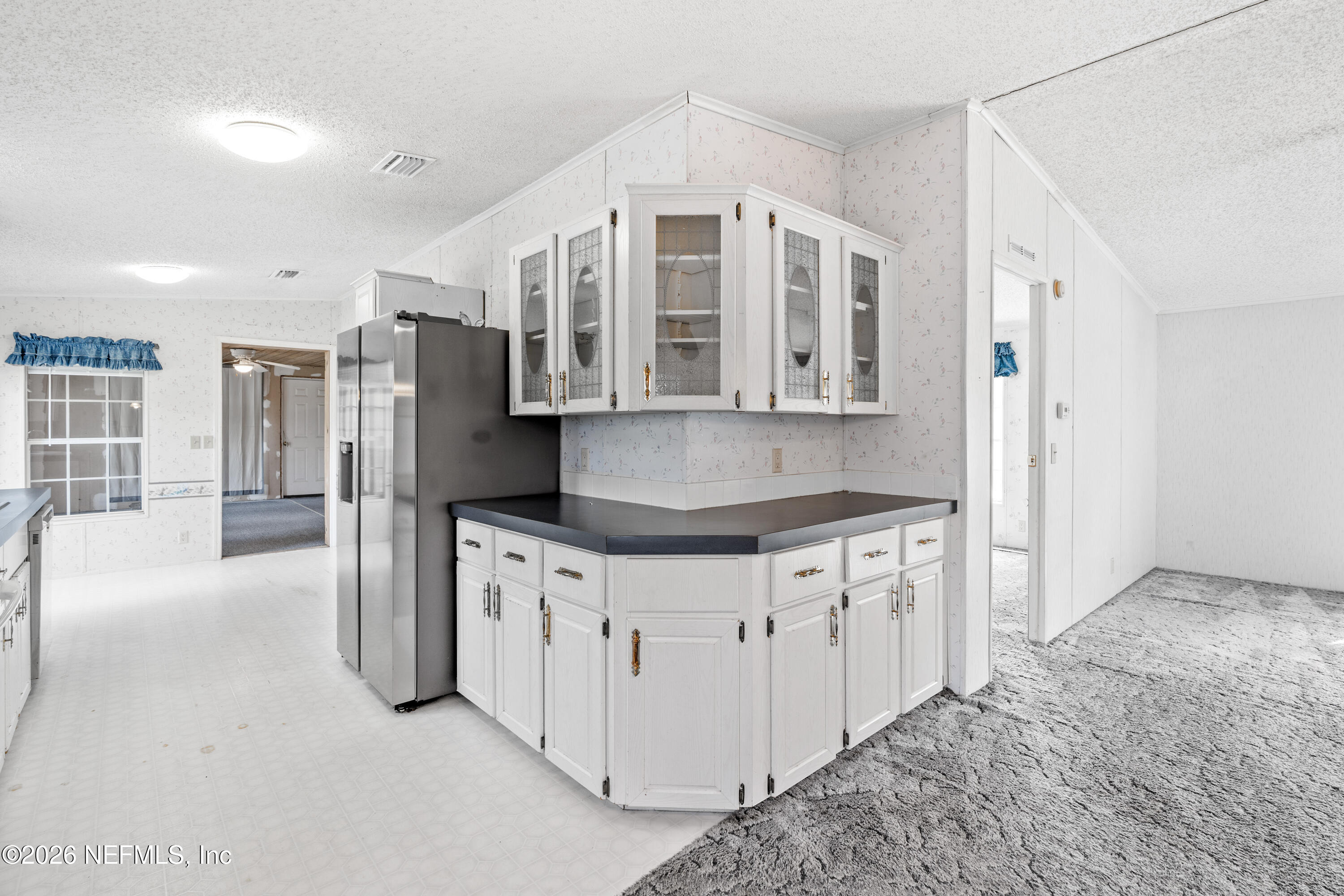 75026 Semper Fi Drive Yulee, FL 32097 - Photo 11 of 43 a kitchen with stainless steel appliances granite countertop a stove and a refrigerator