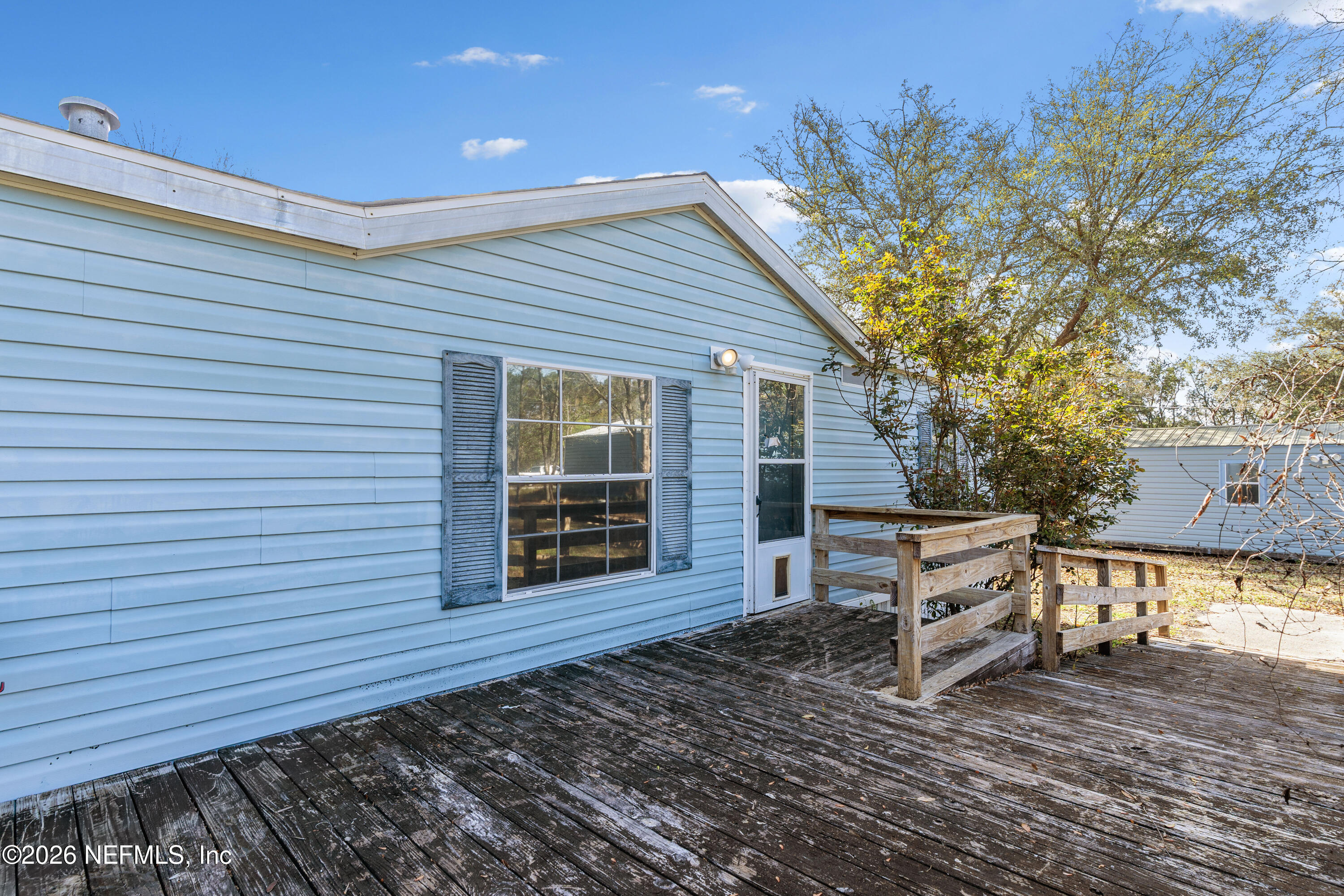 75026 Semper Fi Drive Yulee, FL 32097 - Photo 2 of 43 a view of a house with a wooden fence
