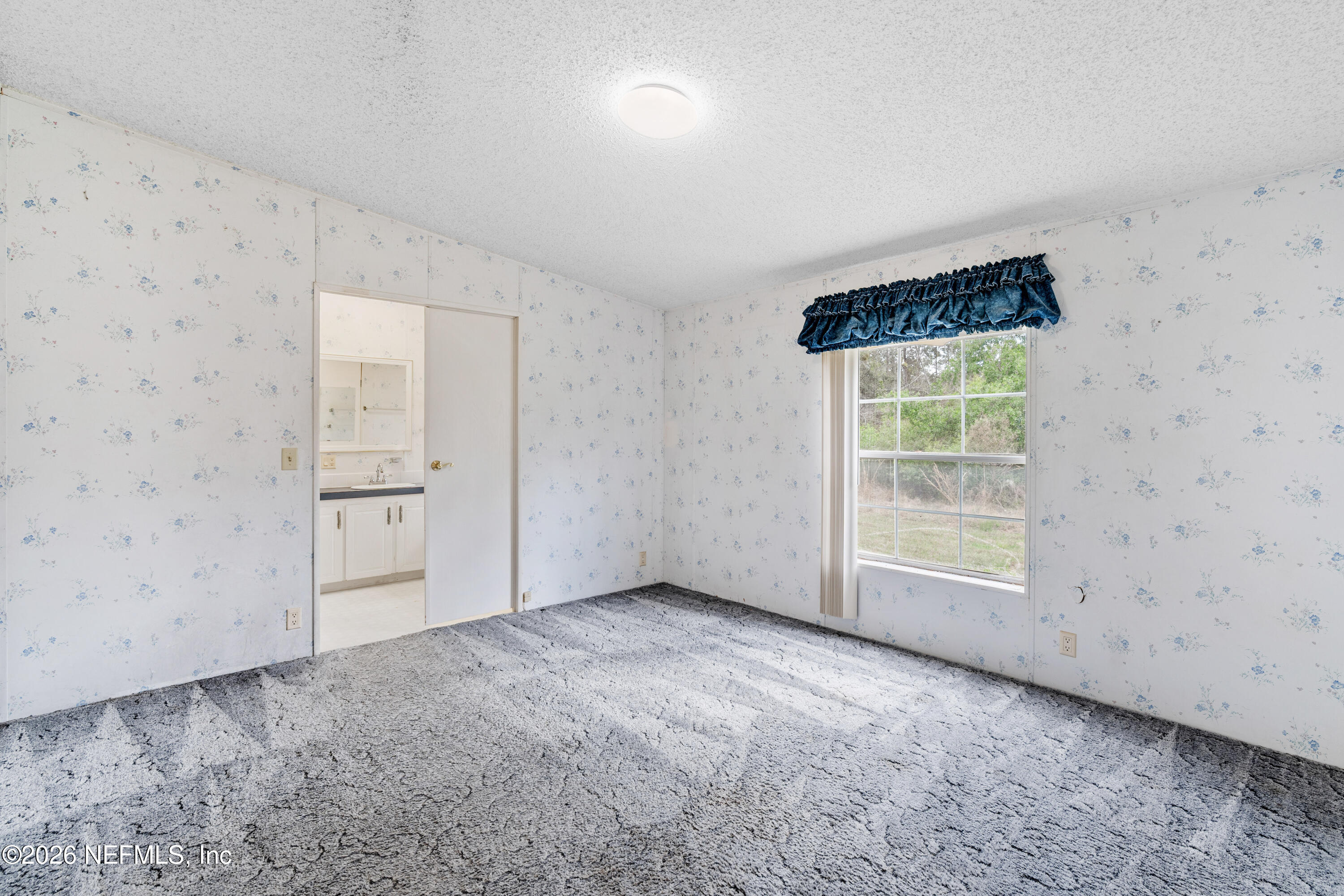 75026 Semper Fi Drive Yulee, FL 32097 - Photo 21 of 43 an empty room with windows