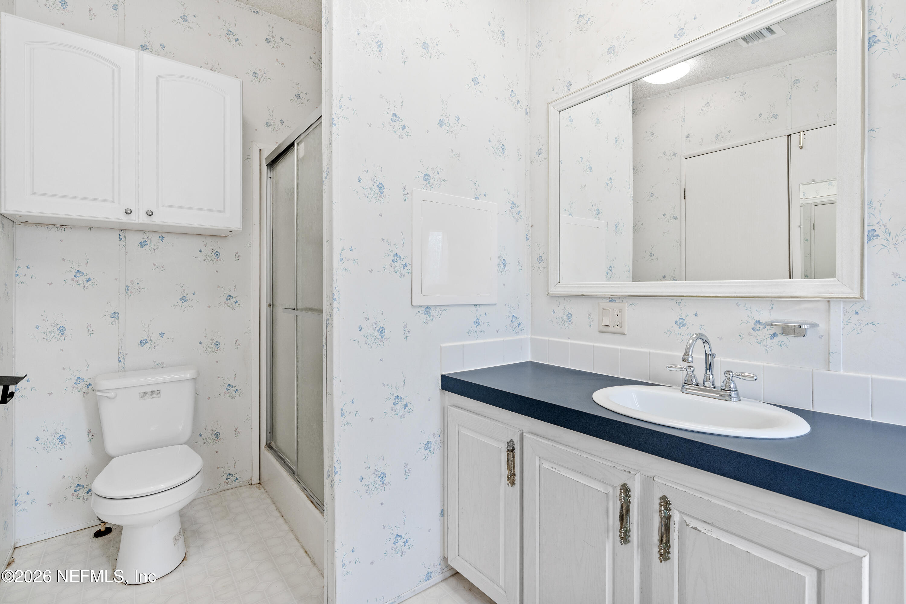 75026 Semper Fi Drive Yulee, FL 32097 - Photo 24 of 43 a bathroom with a toilet sink and mirror