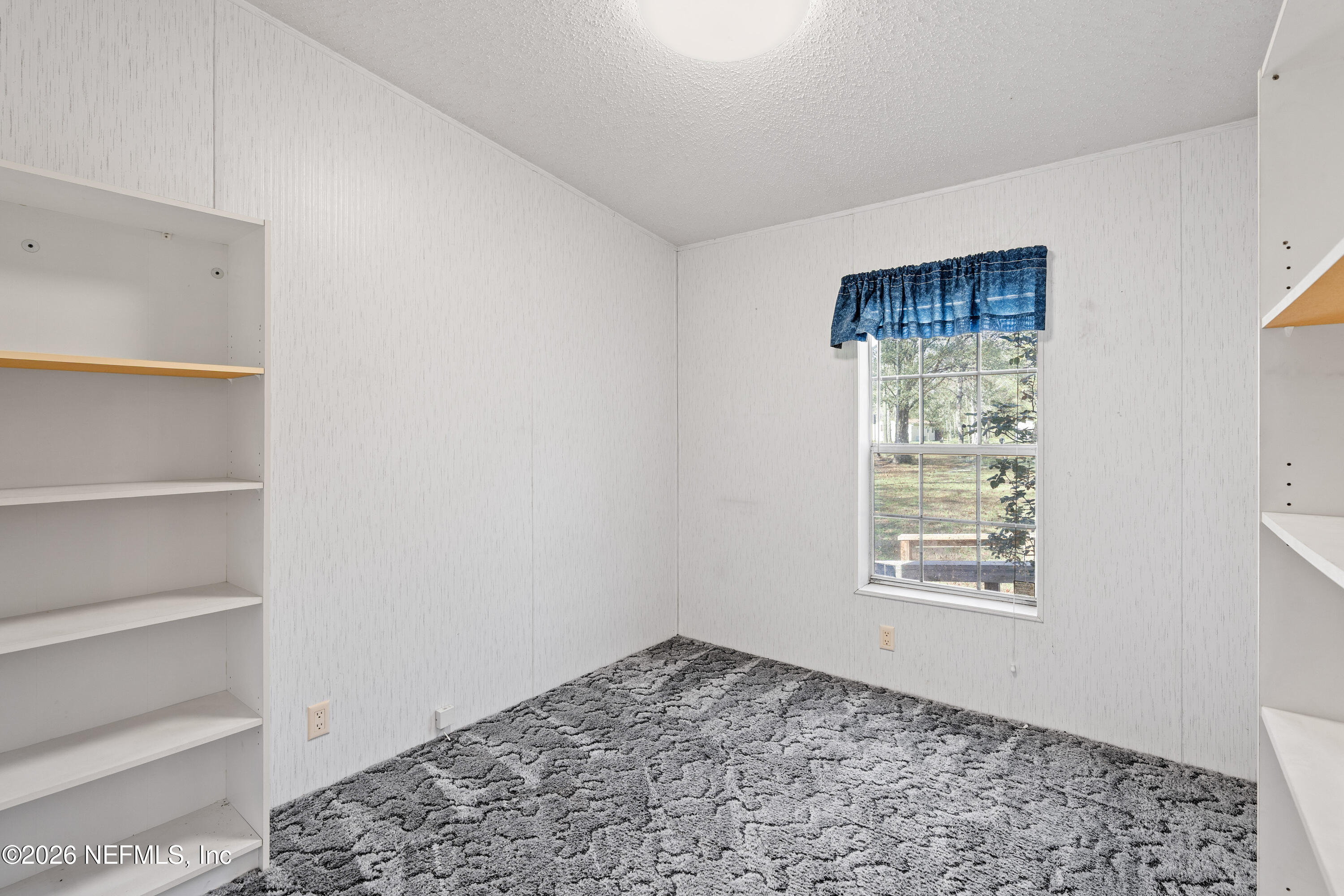 75026 Semper Fi Drive Yulee, FL 32097 - Photo 28 of 43 a view of a bedroom with a window