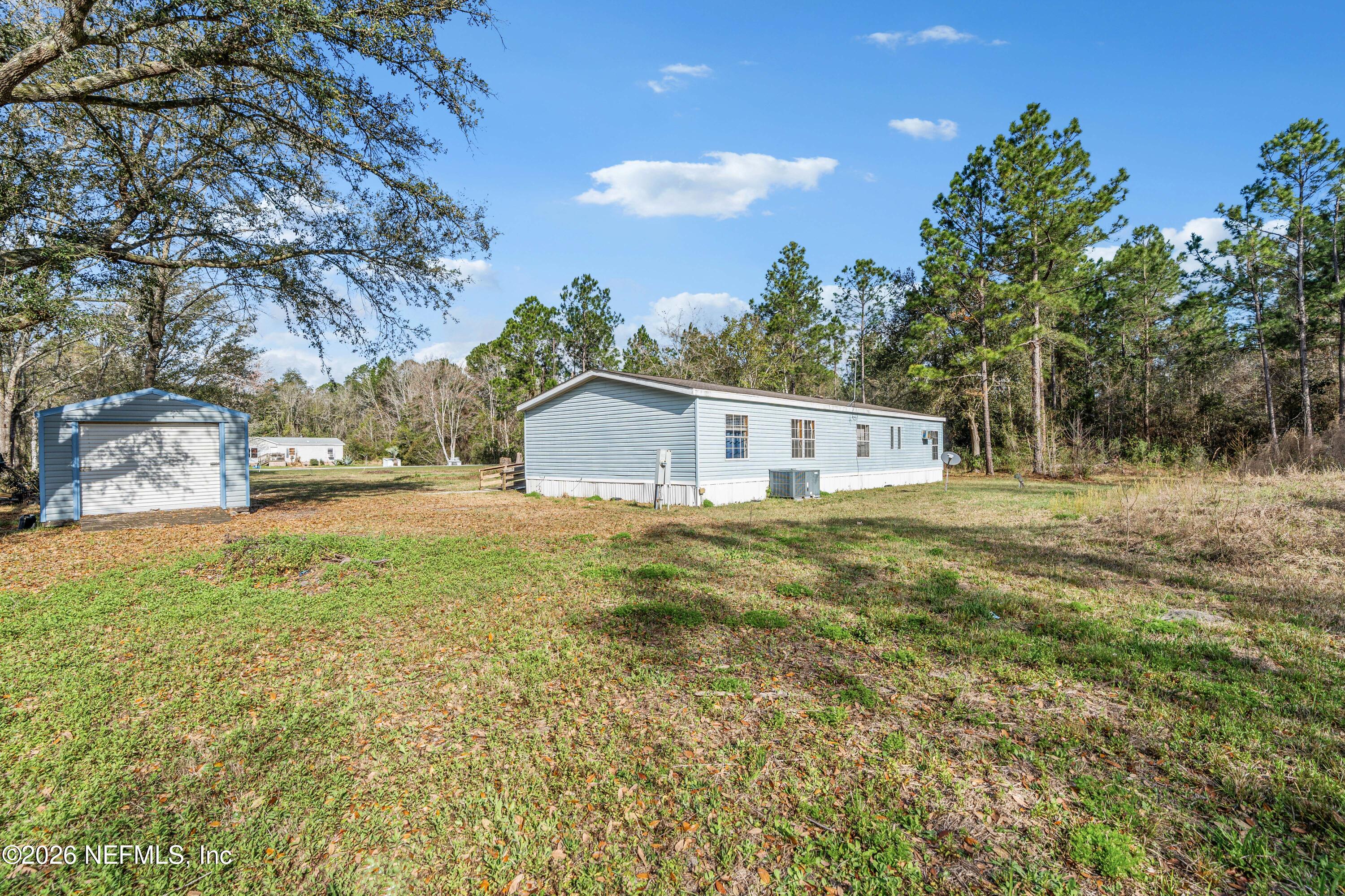 75026 Semper Fi Drive Yulee, FL 32097 - Photo 33 of 43 a front view of a house with a yard