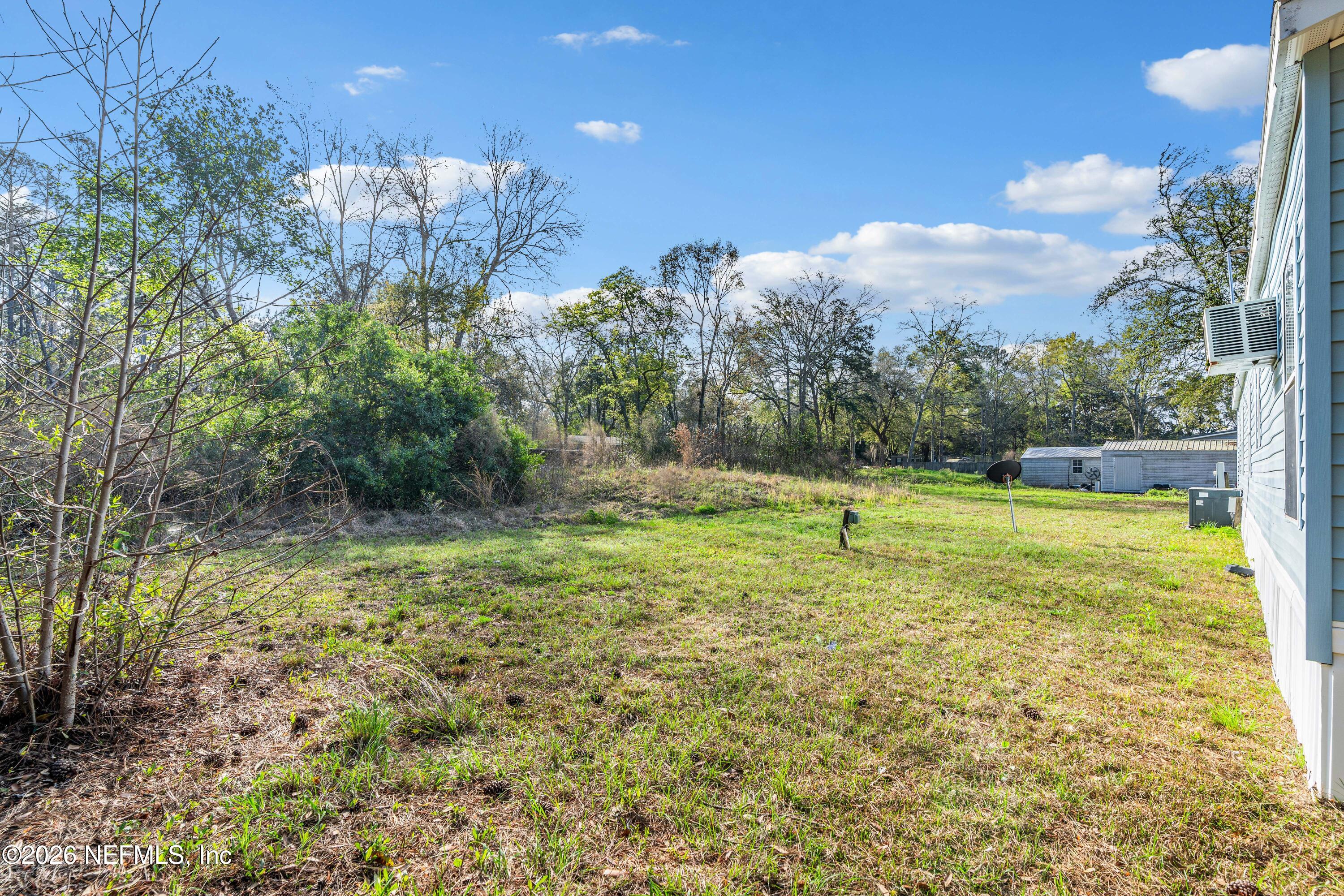 75026 Semper Fi Drive Yulee, FL 32097 - Photo 35 of 43 a view of a yard with a house