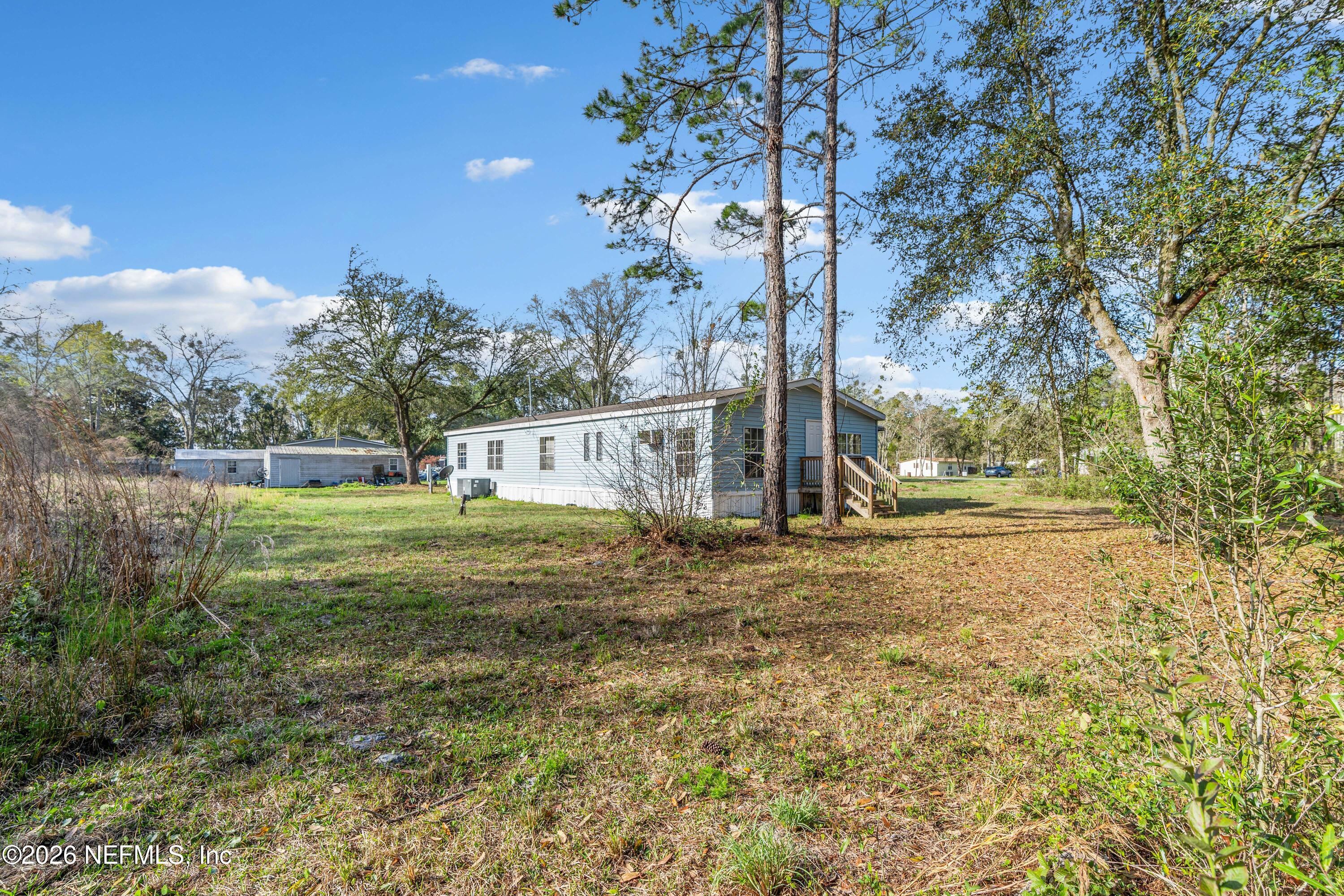 75026 Semper Fi Drive Yulee, FL 32097 - Photo 36 of 43 a view of a house with a yard