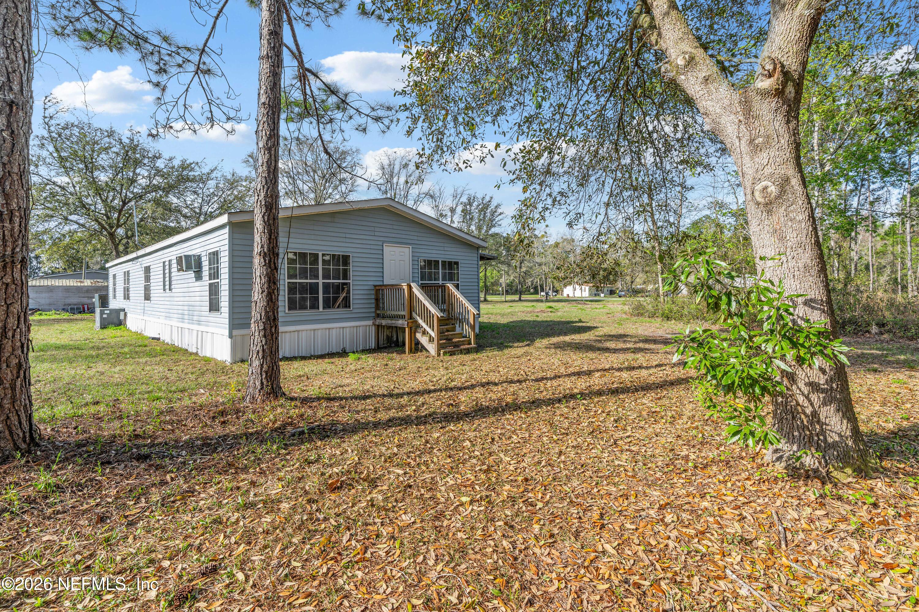75026 Semper Fi Drive Yulee, FL 32097 - Photo 37 of 43 a view of a house with a yard and large trees