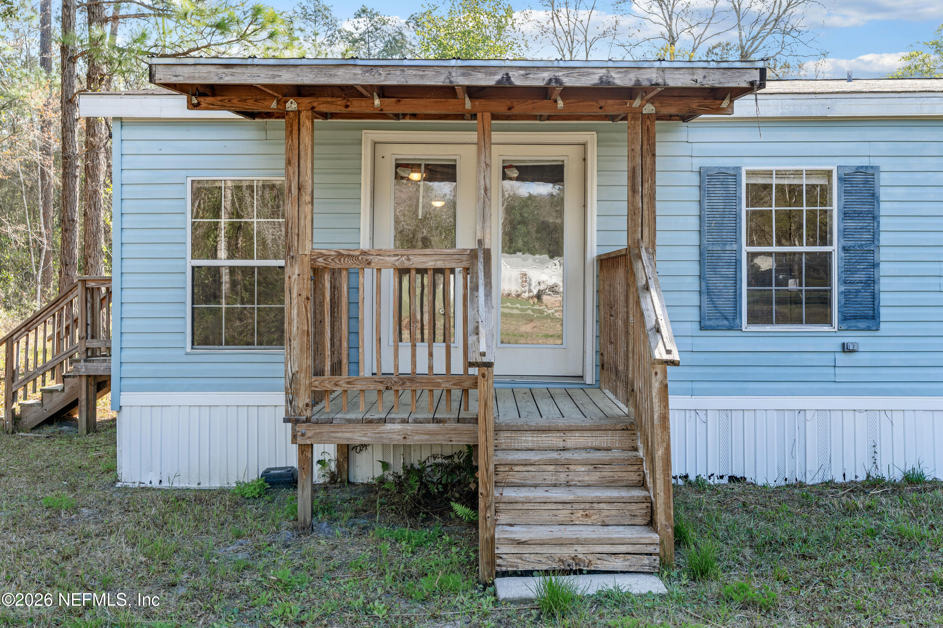 75026 Semper Fi Drive Yulee, FL 32097 - Photo 39 of 43 a view of a house with a small yard and wooden floor and fence