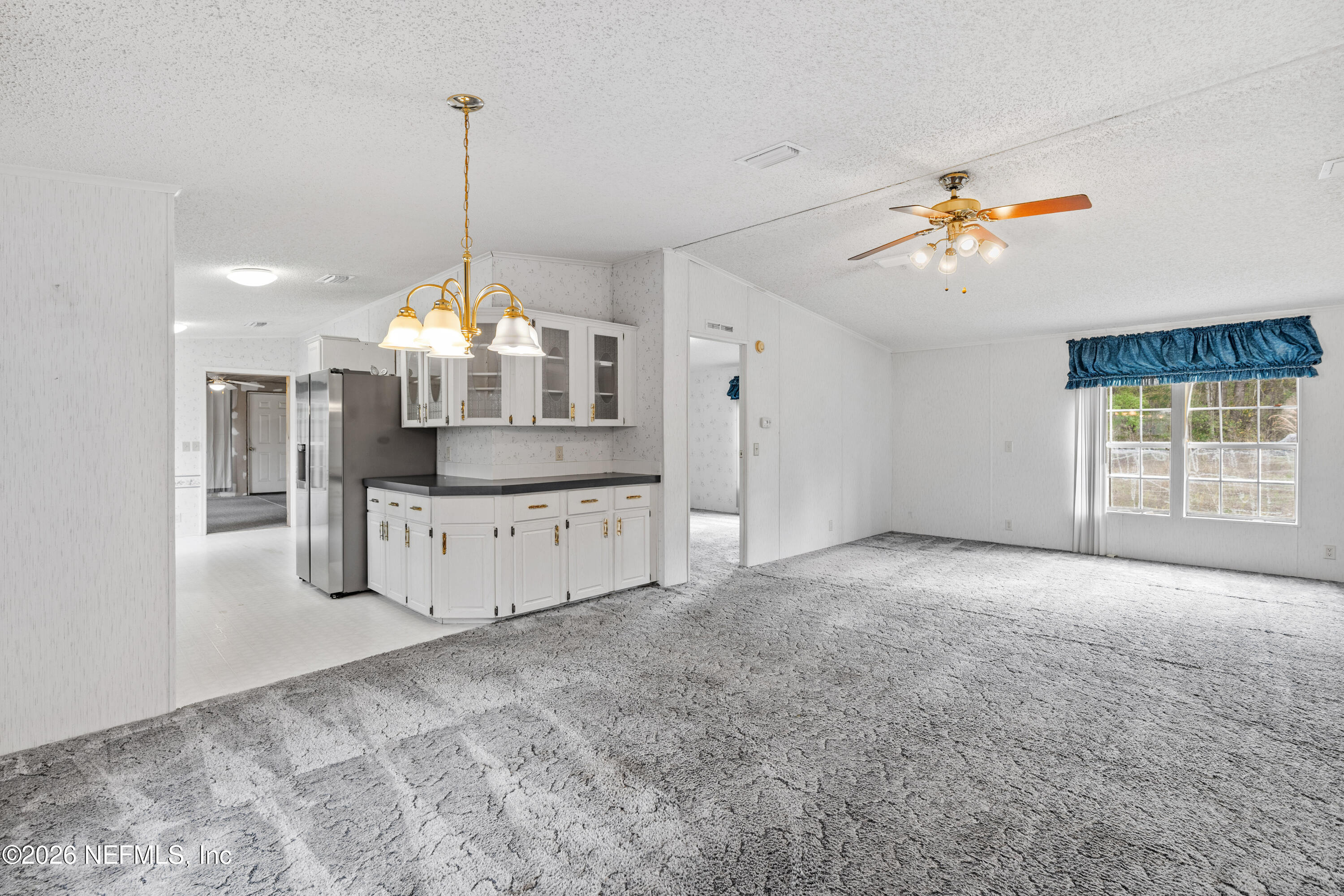 75026 Semper Fi Drive Yulee, FL 32097 - Photo 7 of 43 a view of a kitchen with a stove cabinets and a chandelier