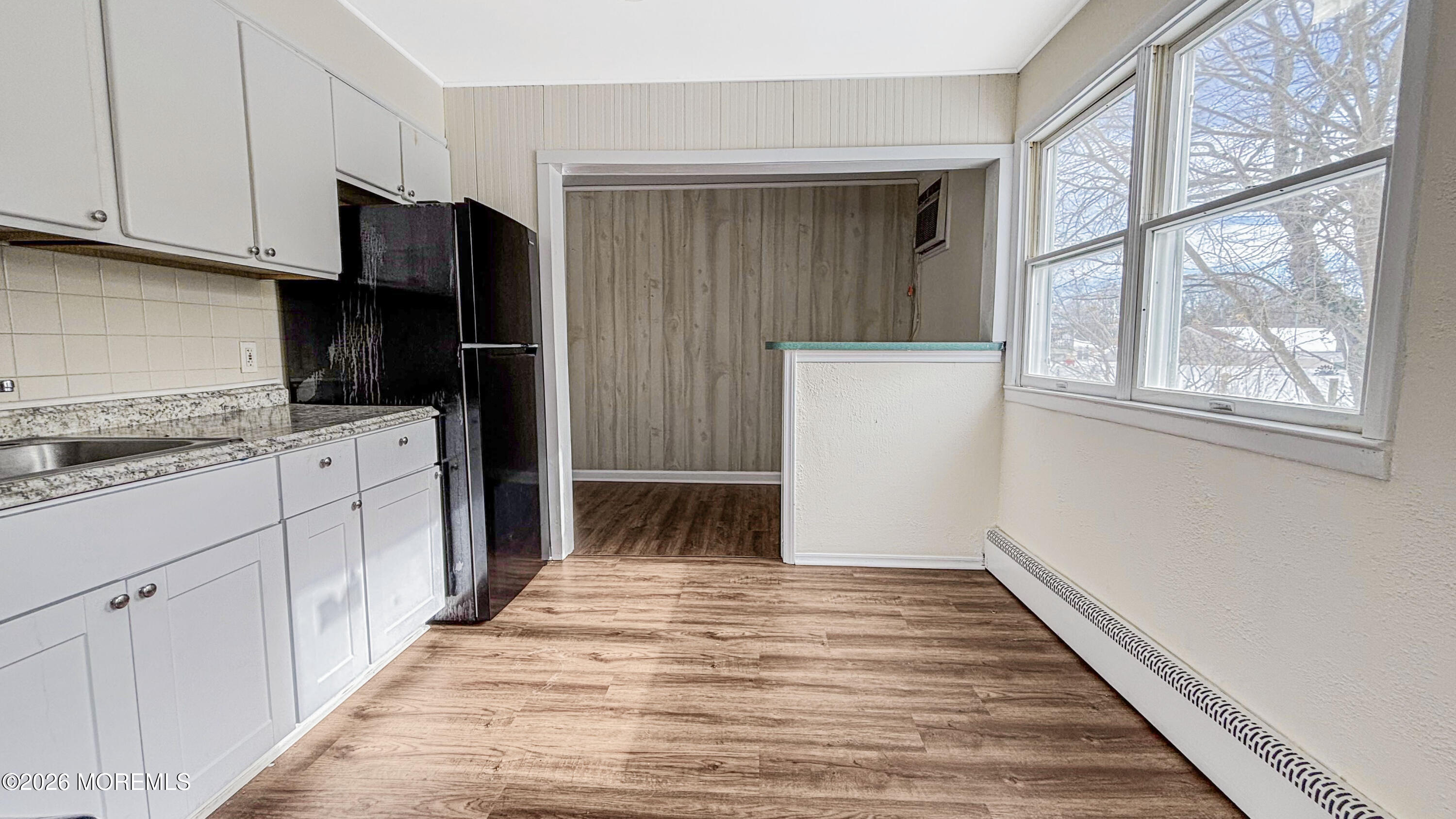 385 Delaware Drive Brick, NJ 08723 - Photo 7 of 16 a kitchen with white cabinets and black appliances