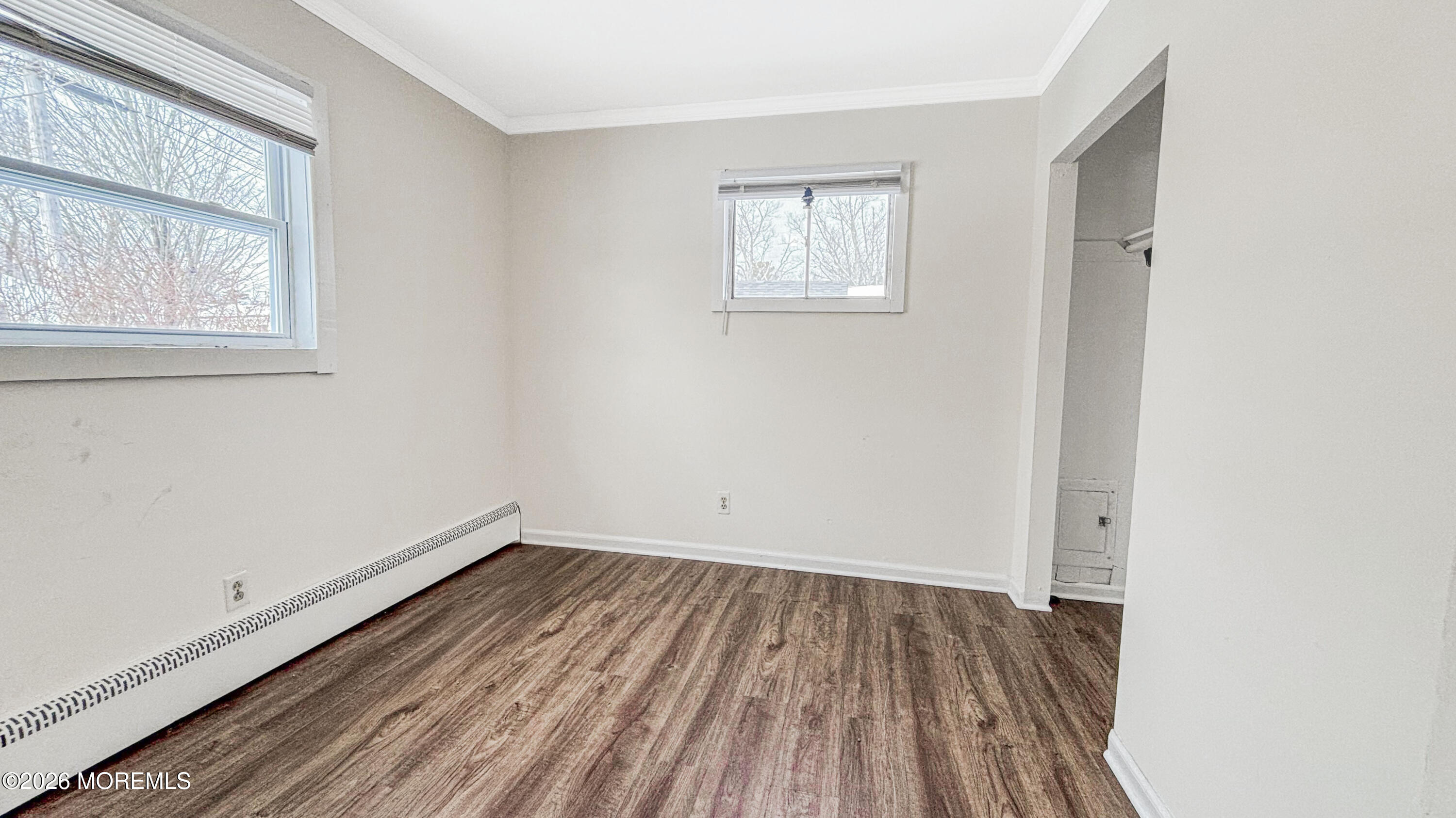 385 Delaware Drive Brick, NJ 08723 - Photo 8 of 16 an empty room with wooden floor and windows