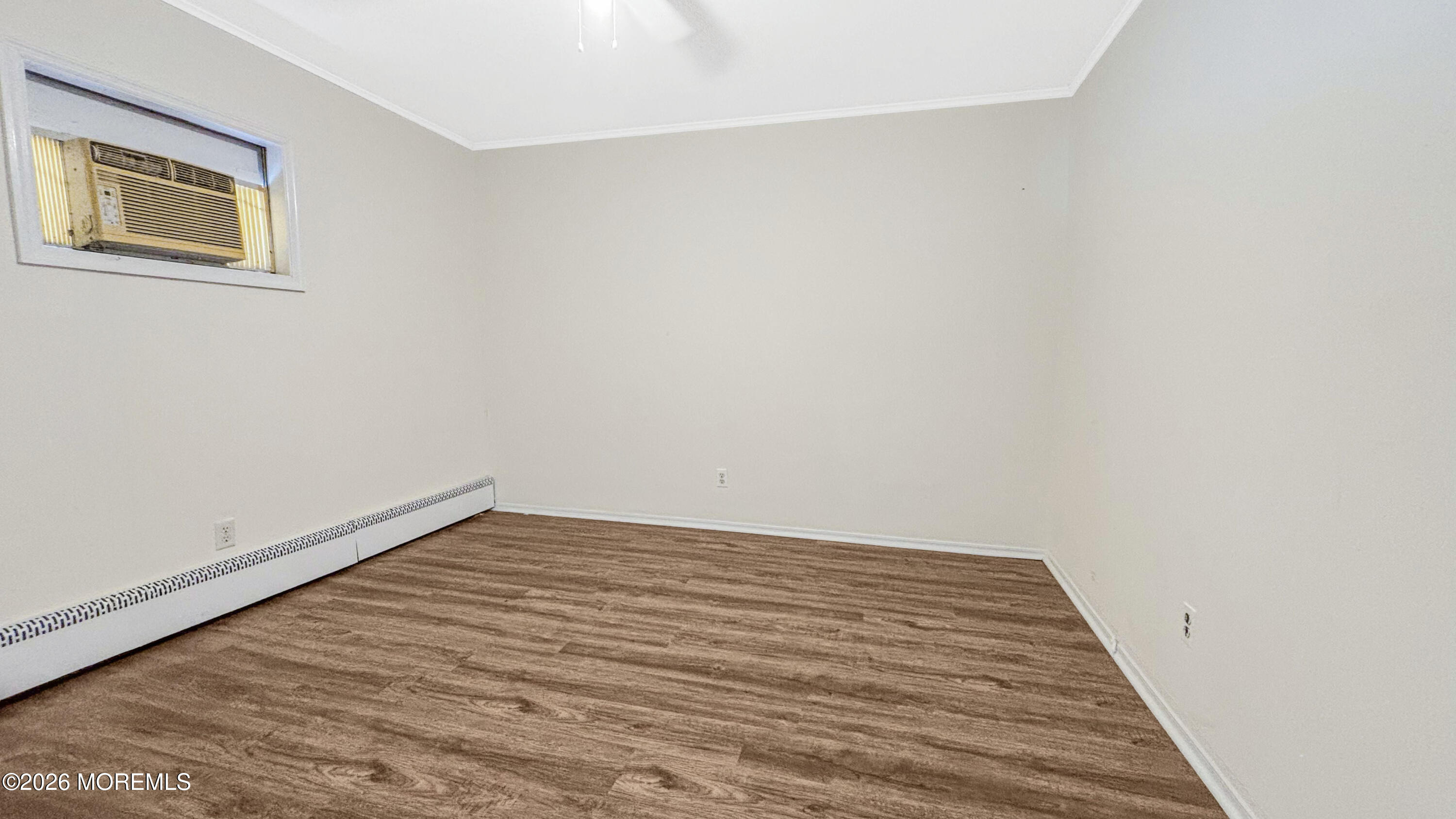 385 Delaware Drive Brick, NJ 08723 - Photo 9 of 16 a view of a room with wooden floor and white walls