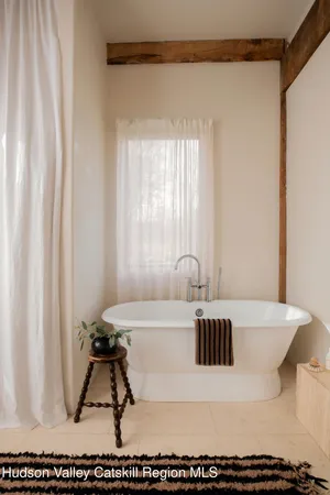 a bathroom with a bathtub and a window