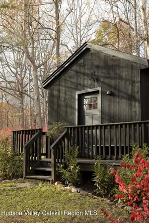 a view of a bedroom with a bed and a table in it