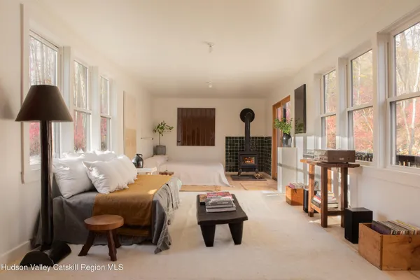 a living room with furniture a flat screen tv and large window