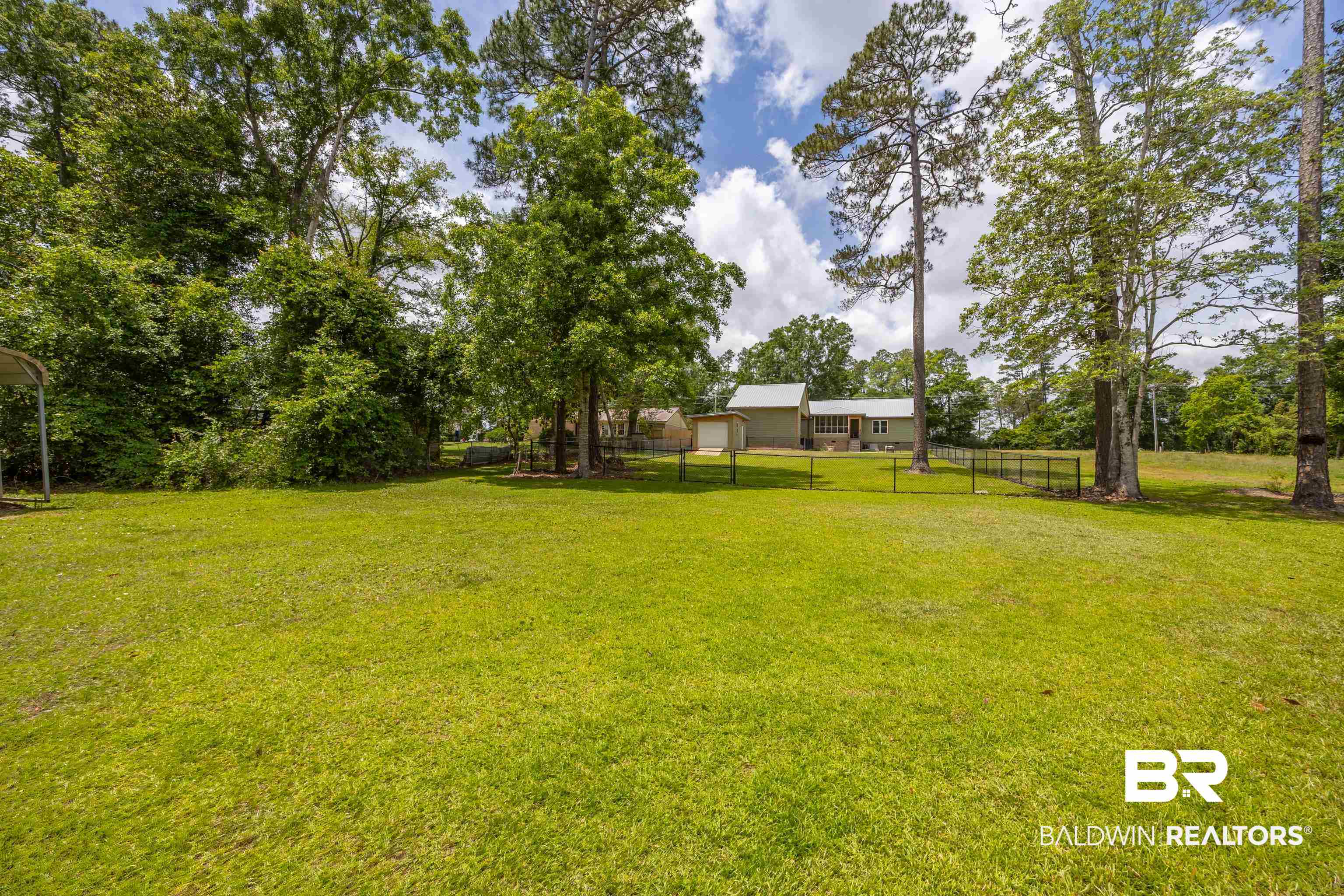 9771 Clarke Ridge Road Foley, AL 36535 - Photo 7 of 72 View of yard with fence.