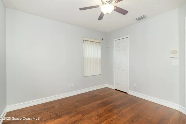 an empty room with windows and closet